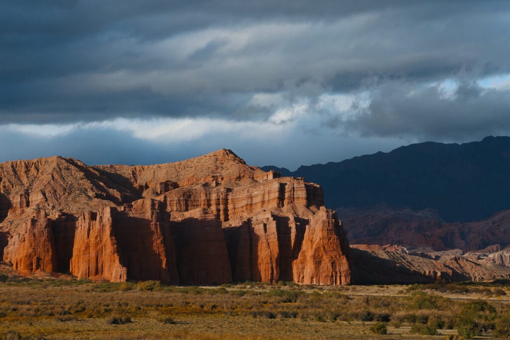 Rugged red mountains tower over the desert of Salta