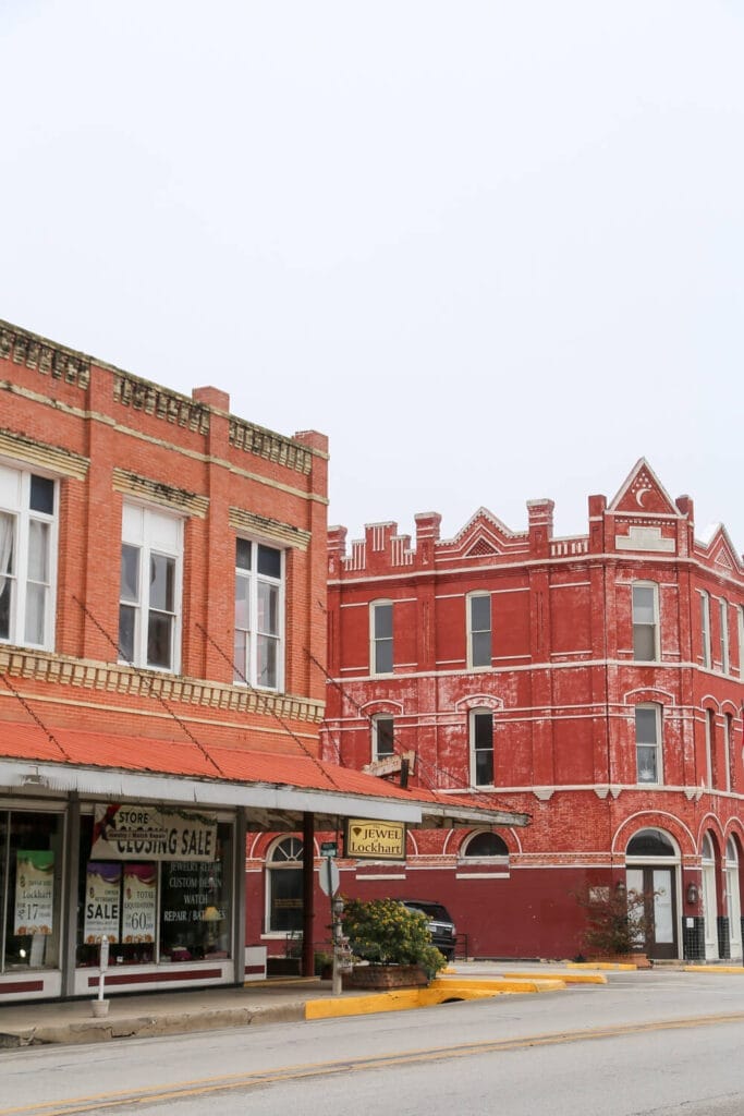 Red brick buildings on a street corner on an overcast day