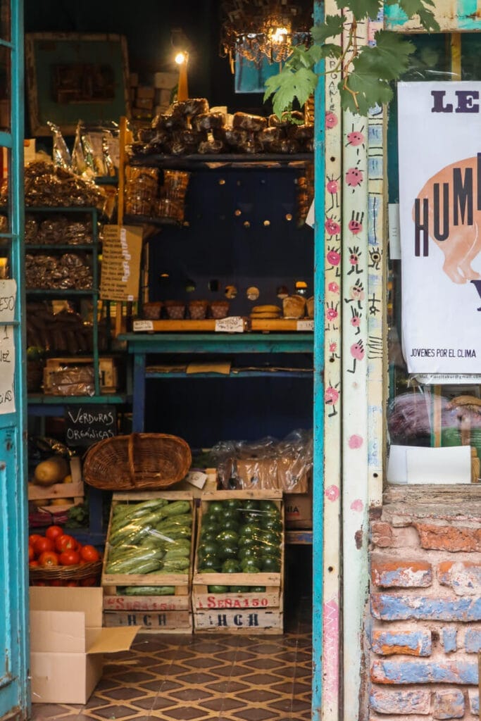 An open door shows produce and baked goods inside a store