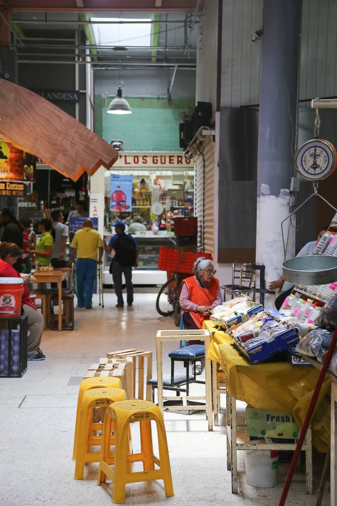 Yellow stool surround a Mexico City market stall