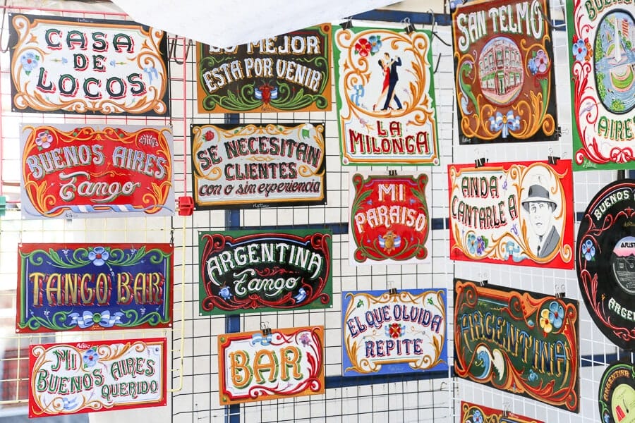 Colorful signs hang on a metal grid