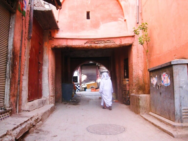 A woman walks under an archway