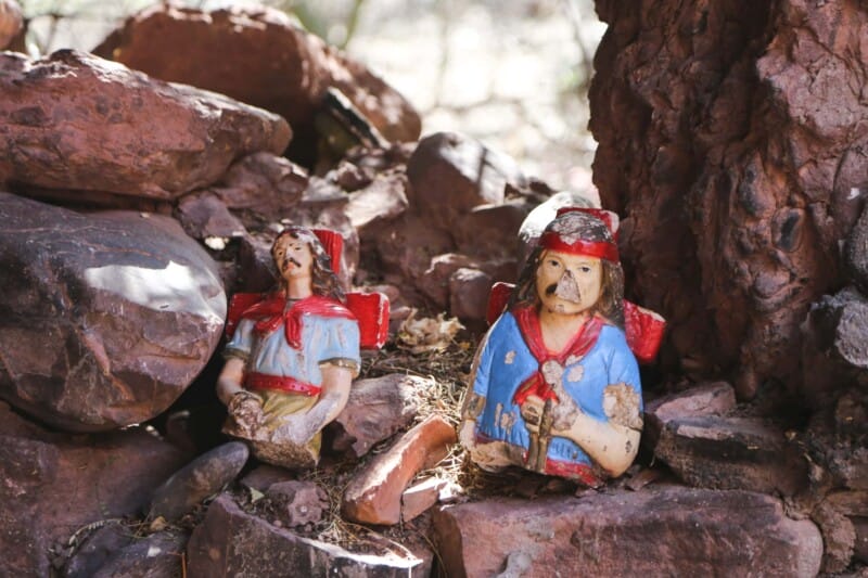 two broken statues in the rocks