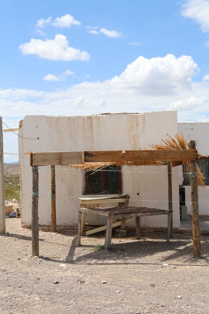 A white adobe building with a table out front