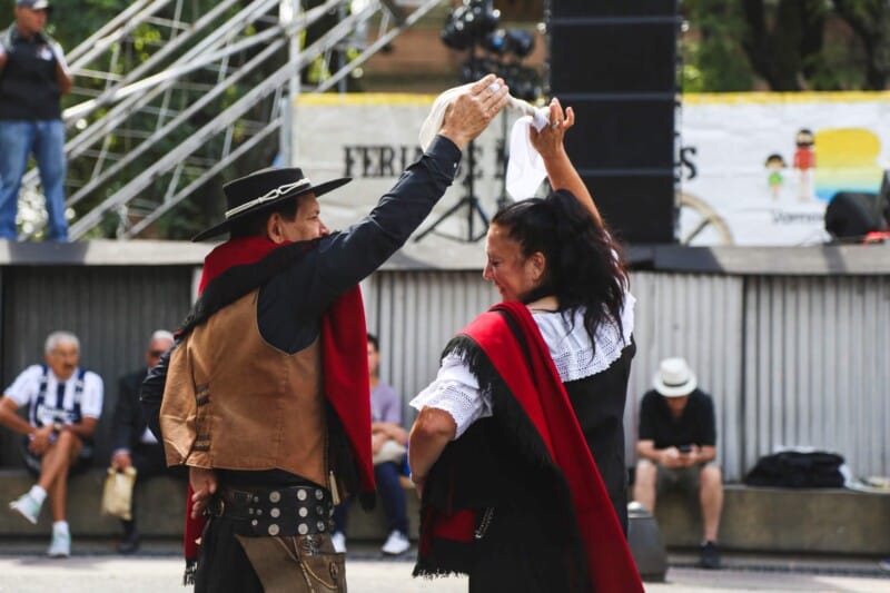 A man and woman dance outdoors