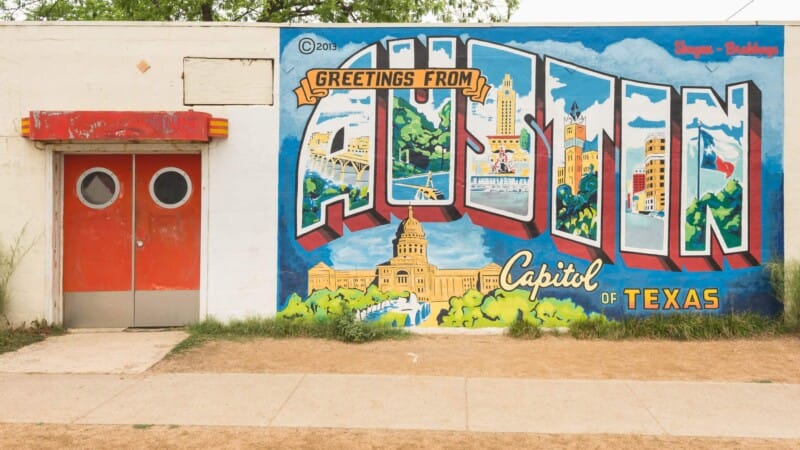 A mural of Austin Texas on an old vintage building
