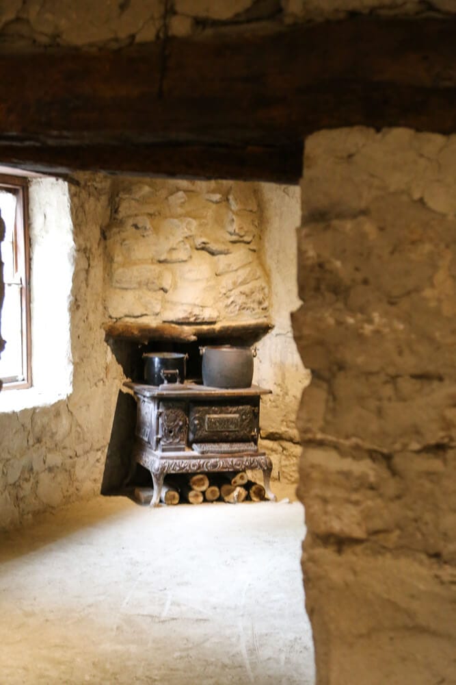 An antique stove in a stone building