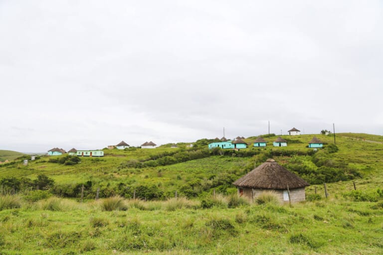 Round huts with thatched roofs on a hill