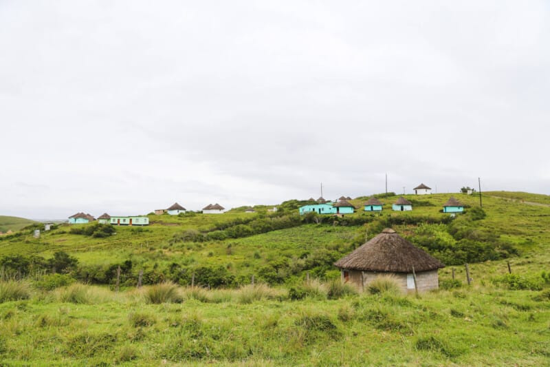 Round huts with thatched roofs on a hill
