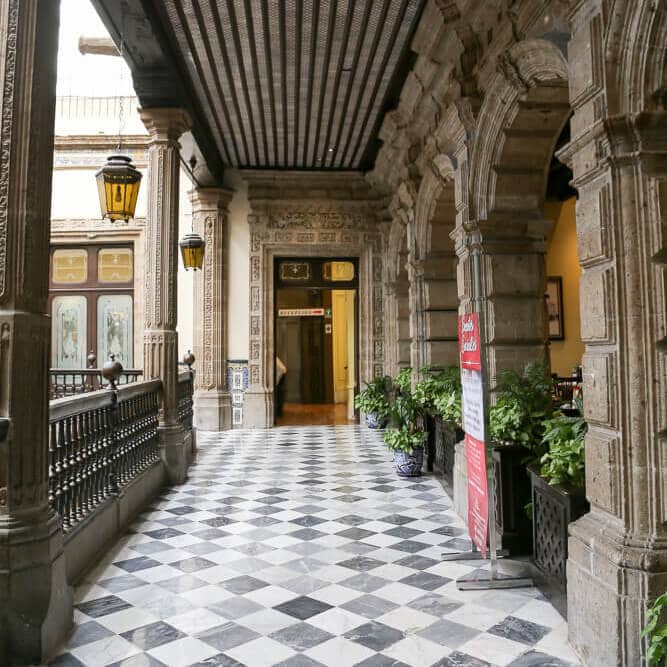 A hallway overlooks an inner courtyard in Mexico City