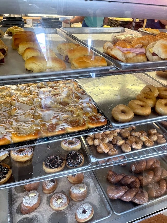 Trays of donuts and pastries in a bakery