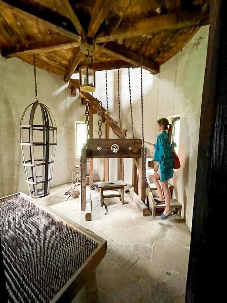 Torture devices like stocks and a bed of nails in a dungeon