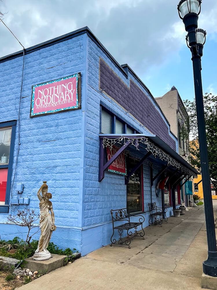 A blue fake brick building with Christmas lights