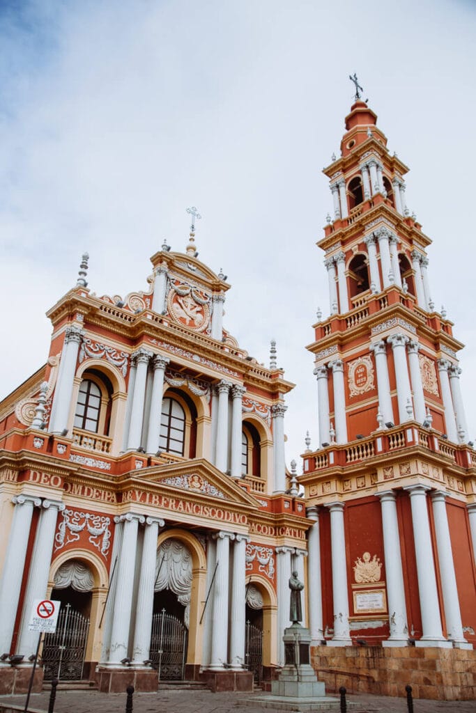 A red and yellow church with white columns