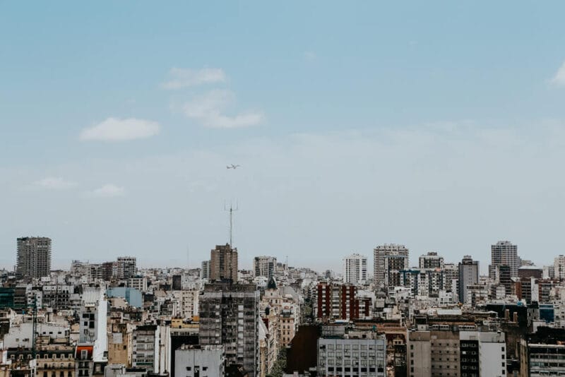 A plane flies over a congested city