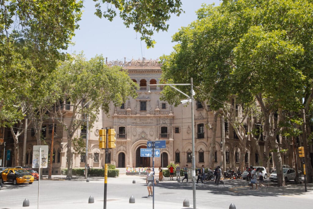 An ornate Spanish style building takes up an entire city corner in Mendoza Argentina
