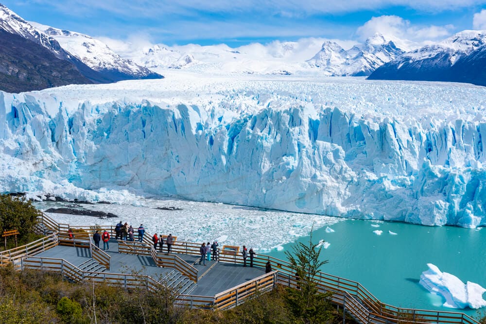 Tourists stand on the viewing decks in front of the Perito Moreno Glacier in El Calafate