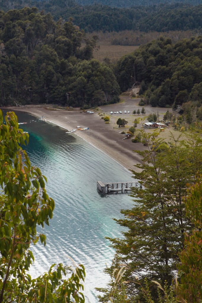 Lago Espejo Grande seen from above with a wooden pier jutting into the water