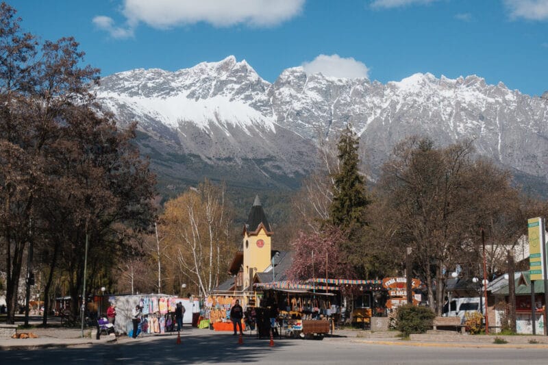 A snowy mountain towers over a downtown Patagonian village