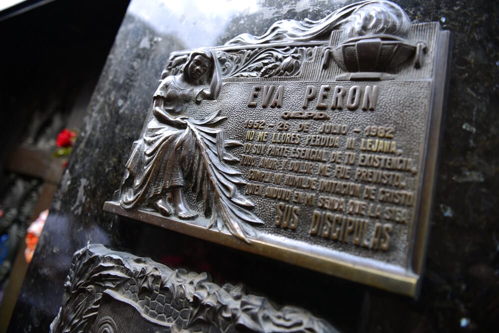A close up photo of a metal plaque for Eva Peron on her grave