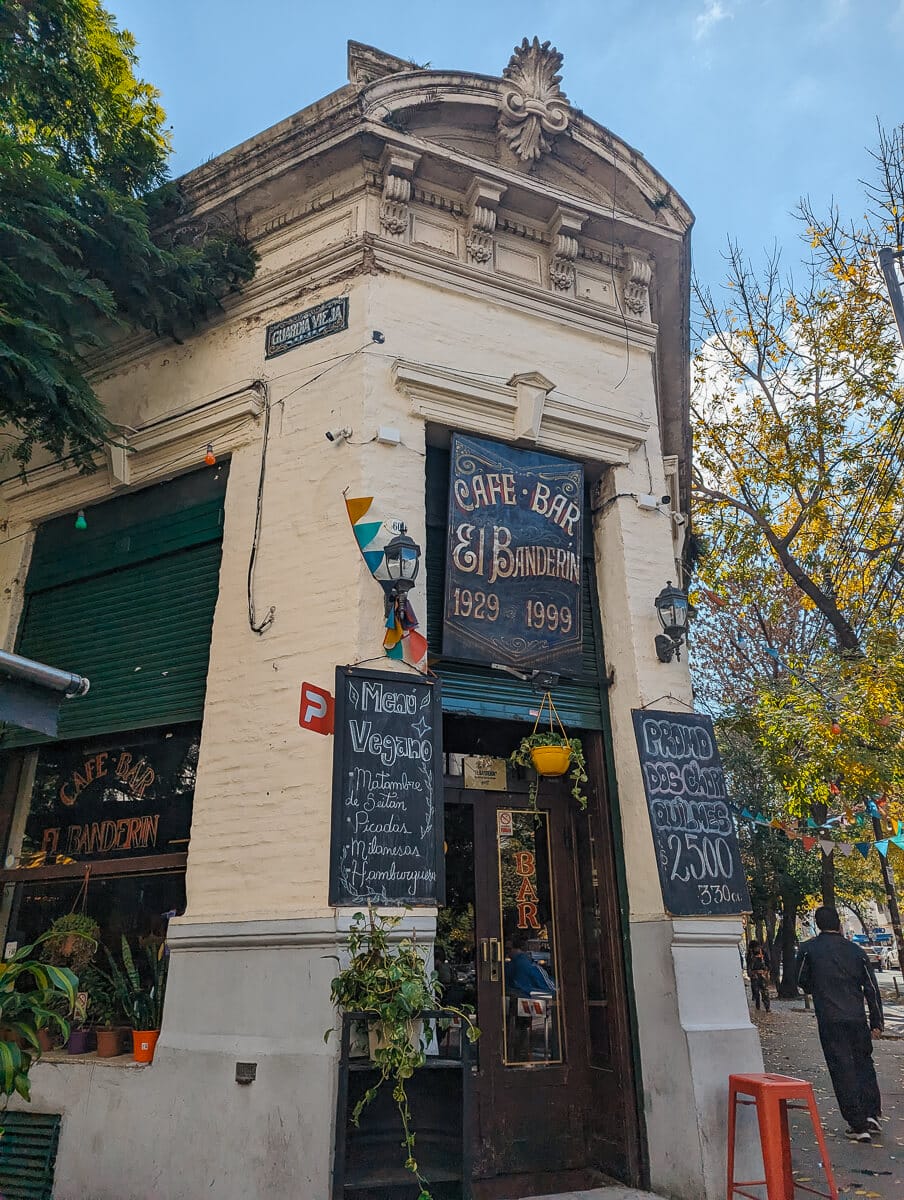 A historic street corner bar in Buenos Aires with chalkboard menus by the front door