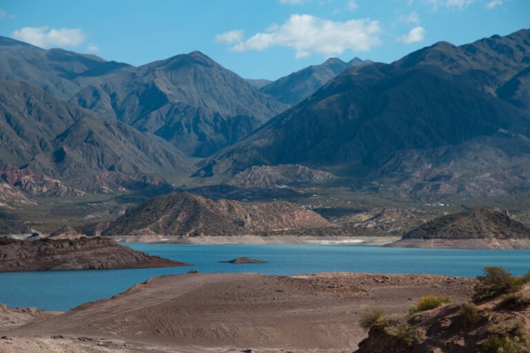 The turquoise waters of the Potrerillos lake next to the Andes mountains